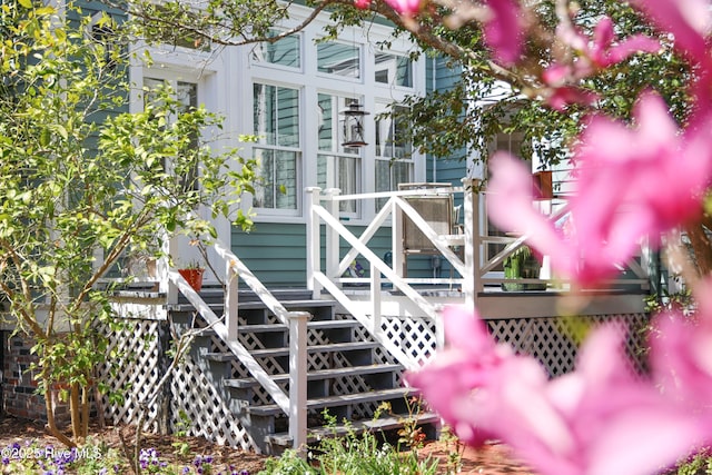 exterior space featuring a wooden deck and stairway