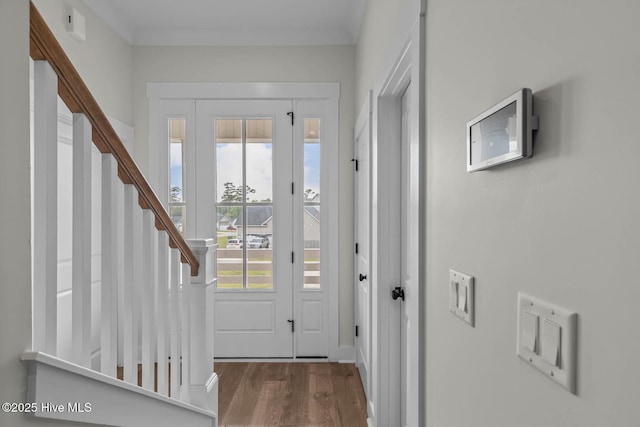 doorway to outside with wood finished floors and stairway