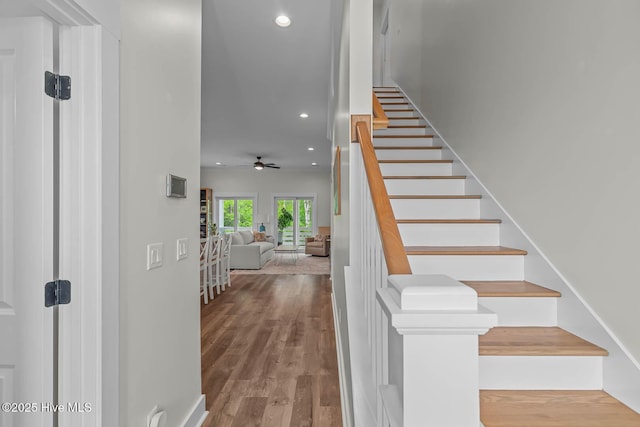 staircase featuring ceiling fan, recessed lighting, and wood finished floors
