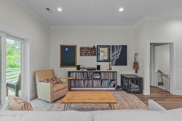 sitting room featuring crown molding, recessed lighting, wood finished floors, and visible vents