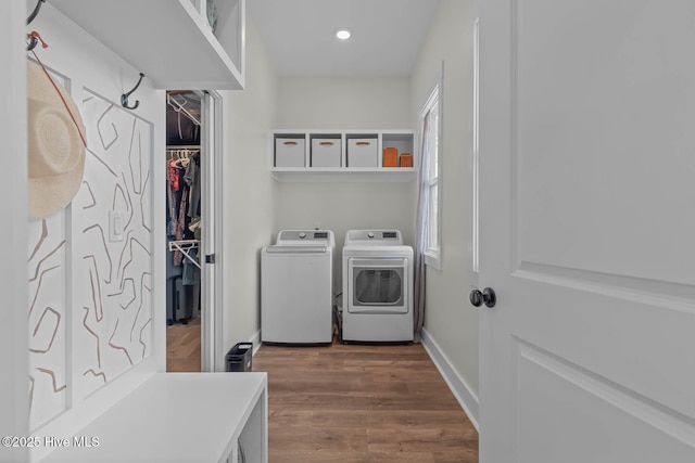 clothes washing area featuring laundry area, washer and dryer, baseboards, dark wood-style floors, and recessed lighting