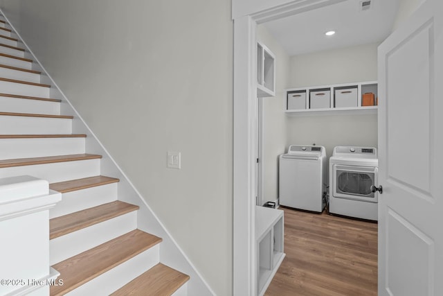laundry room featuring laundry area, visible vents, wood finished floors, recessed lighting, and washer and clothes dryer