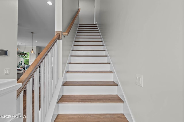 staircase featuring recessed lighting and wood finished floors