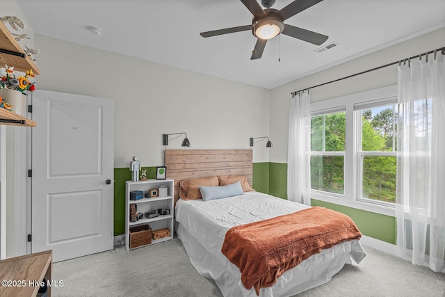 bedroom with carpet flooring, ceiling fan, and visible vents