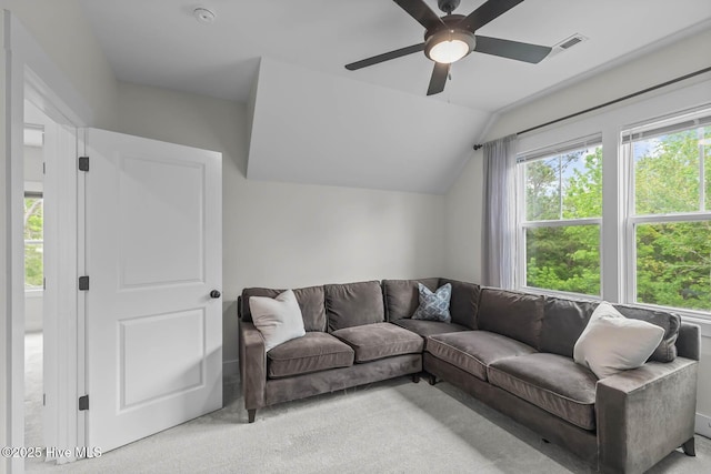 living room with light colored carpet, ceiling fan, visible vents, and lofted ceiling