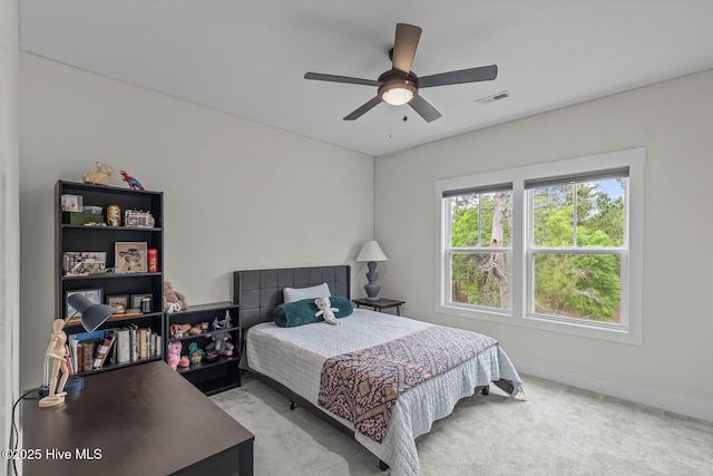 carpeted bedroom with a ceiling fan, baseboards, and visible vents