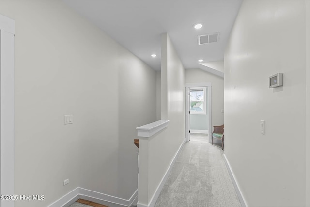 corridor featuring visible vents, baseboards, recessed lighting, carpet, and an upstairs landing
