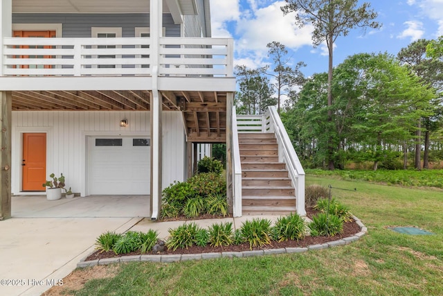 view of side of property featuring a garage, a lawn, stairs, and concrete driveway