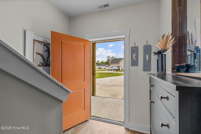 doorway to outside with visible vents and light wood finished floors