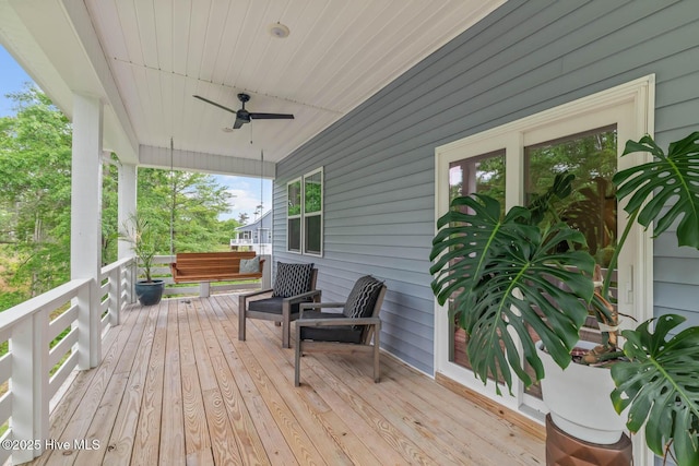wooden deck featuring a porch and a ceiling fan