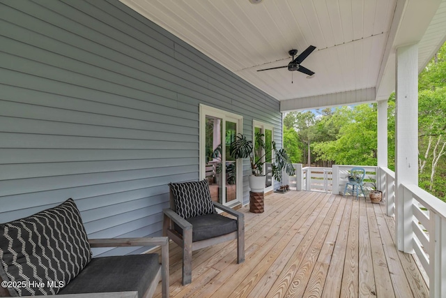deck with a ceiling fan and covered porch