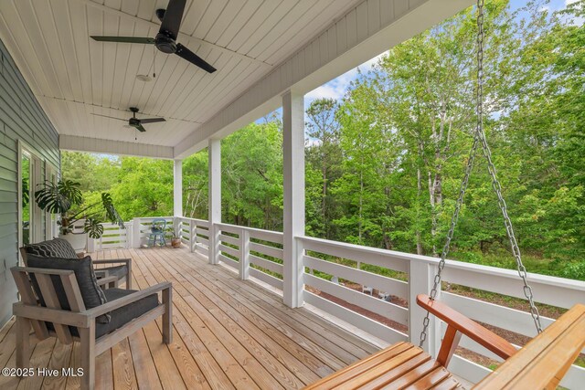deck with covered porch and a ceiling fan