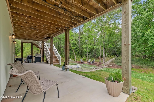view of patio / terrace featuring stairway and a grill