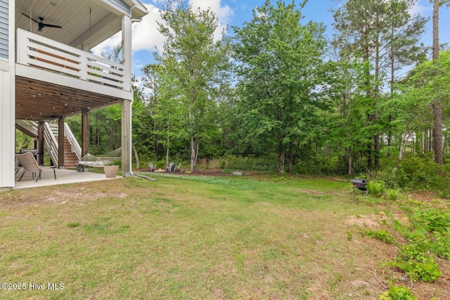 view of yard featuring stairs, a patio area, and a deck