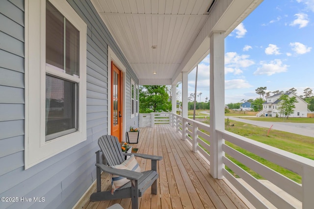 wooden deck with a porch and a residential view