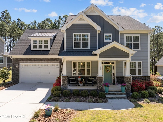 104 Plantation Dr, Southern Pines, NC 28387 - craftsman-style home featuring concrete driveway, board and batten siding, stone siding, a shingled roof, and covered porch