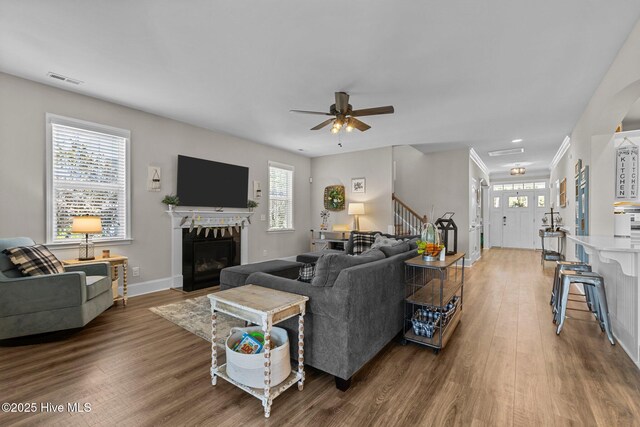 104 Plantation Dr, Southern Pines, NC 28387 - living room with a fireplace with flush hearth, a ceiling fan, visible vents, stairway, and wood finished floors