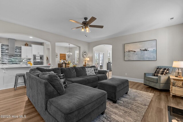 104 Plantation Dr, Southern Pines, NC 28387 - living area featuring baseboards, a ceiling fan, visible vents, arched walkways, and wood finished floors
