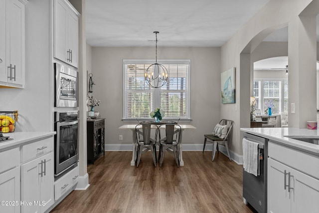 104 Plantation Dr, Southern Pines, NC 28387 - kitchen featuring appliances with stainless steel finishes, wood finished floors, light countertops, and white cabinets