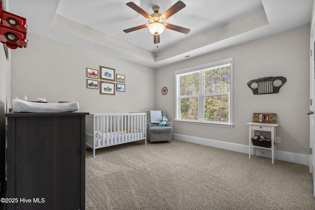 104 Plantation Dr, Southern Pines, NC 28387 - carpeted bedroom featuring a nursery area, baseboards, and a raised ceiling