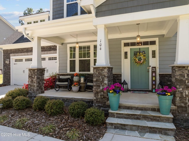104 Plantation Dr, Southern Pines, NC 28387 - view of exterior entry featuring an attached garage, covered porch, and stone siding