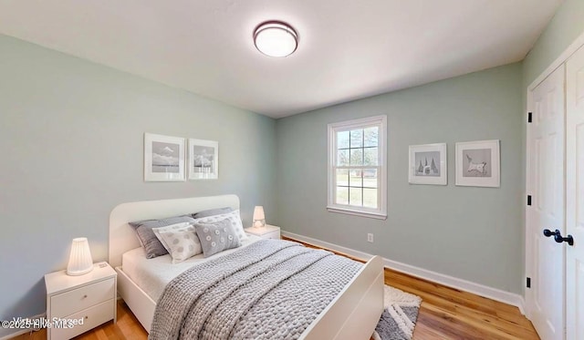 bedroom featuring baseboards and light wood-type flooring
