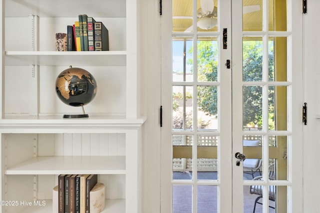 office area with crown molding, an inviting chandelier, french doors, built in shelves, and hardwood / wood-style flooring