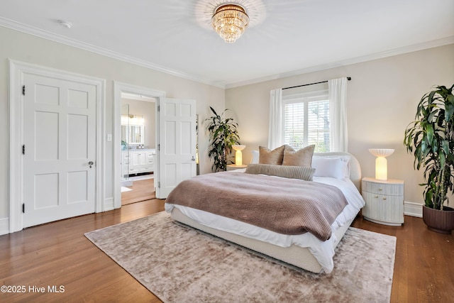 bedroom with a chandelier, ornamental molding, and wood finished floors