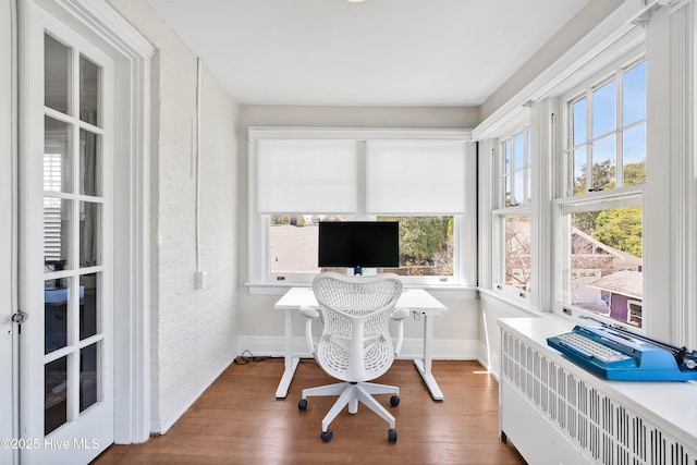 office space with baseboards and wood finished floors