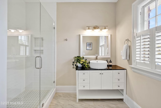 bathroom with baseboards, a shower stall, marble finish floor, and vanity