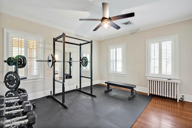 workout room with crown molding, visible vents, radiator heating unit, and a ceiling fan