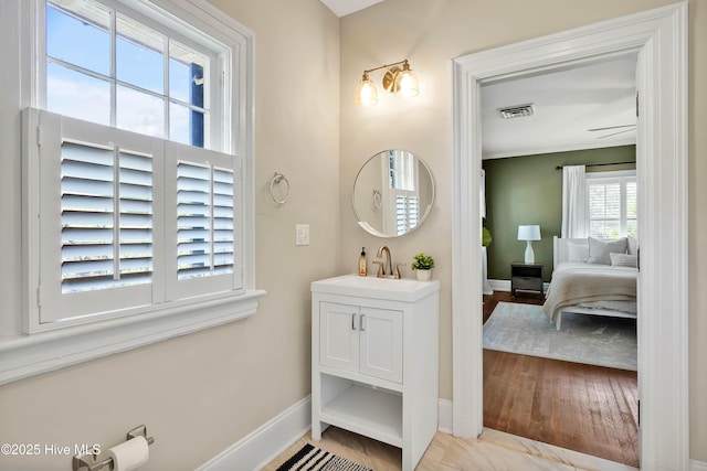bathroom with vanity, baseboards, and visible vents