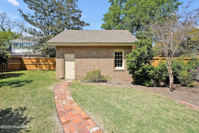 exterior space with fence private yard and an outbuilding