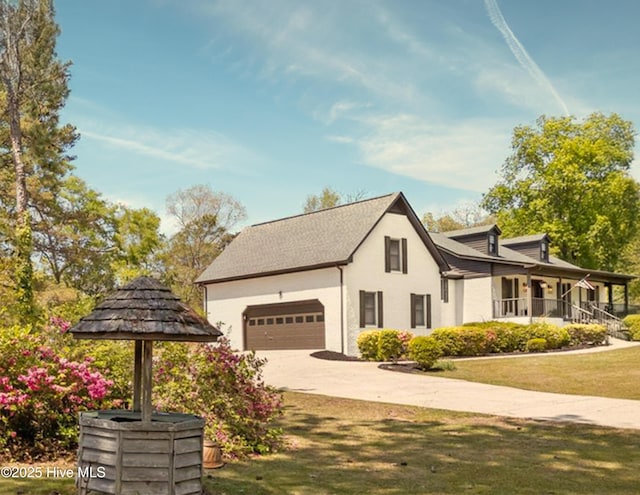 301 Pine Crest Rd, Trent Woods, NC 28562 - view of property exterior featuring an attached garage, driveway, covered porch, a yard, and stucco siding