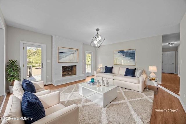 301 Pine Crest Rd, Trent Woods, NC 28562 - living area featuring wood finished floors, healthy amount of natural light, and a large fireplace
