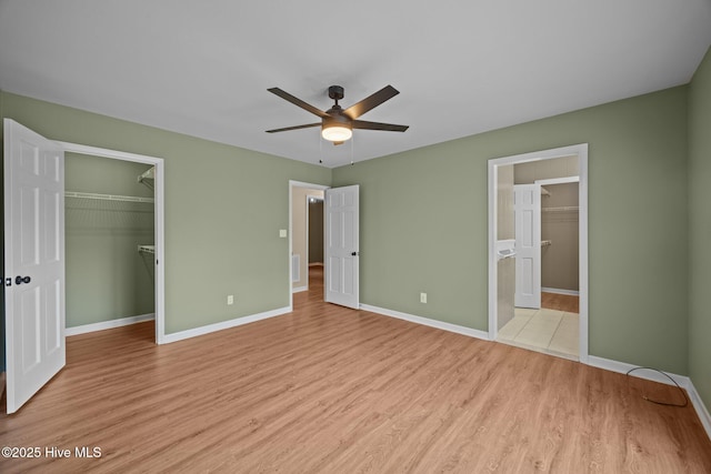 301 Pine Crest Rd, Trent Woods, NC 28562 - unfurnished bedroom with a spacious closet, light wood-style floors, a closet, and baseboards