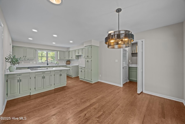 301 Pine Crest Rd, Trent Woods, NC 28562 - kitchen with green cabinets, light countertops, wood finished floors, baseboards, and recessed lighting