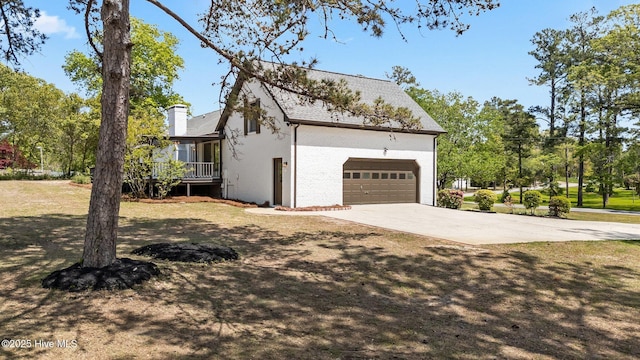 301 Pine Crest Rd, Trent Woods, NC 28562 - view of property exterior with a chimney, concrete driveway, and a garage
