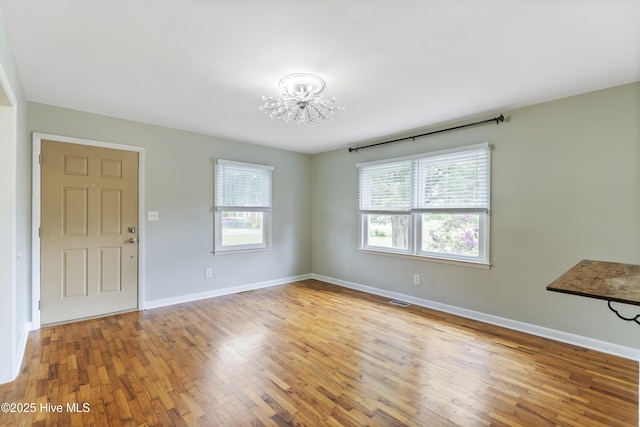 117 Brookfield Dr, Wilmington, NC 28405 - foyer entrance with a chandelier, wood finished floors, and baseboards