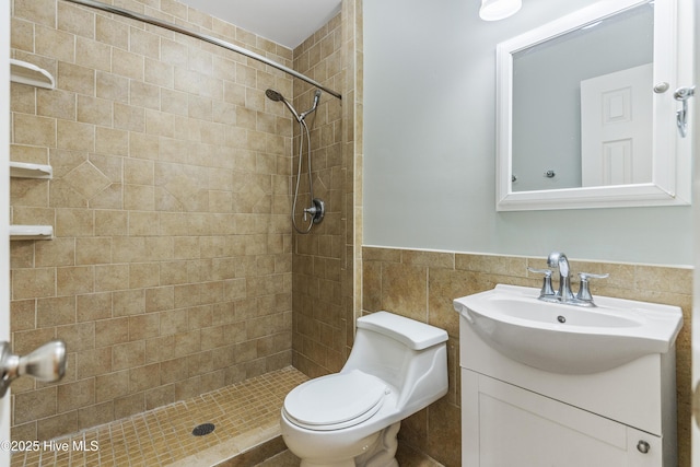117 Brookfield Dr, Wilmington, NC 28405 - full bathroom featuring vanity, tiled shower, toilet, tile walls, and wainscoting