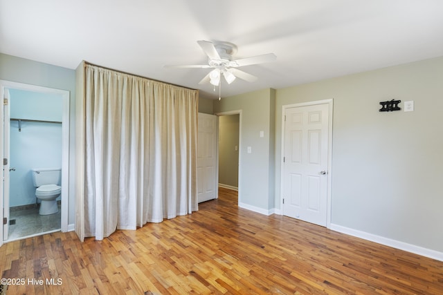117 Brookfield Dr, Wilmington, NC 28405 - unfurnished bedroom featuring light wood-type flooring, baseboards, ensuite bath, and a ceiling fan