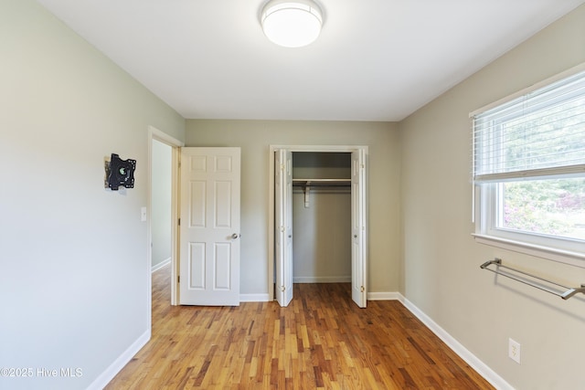 117 Brookfield Dr, Wilmington, NC 28405 - unfurnished bedroom featuring light wood-type flooring, baseboards, and a closet