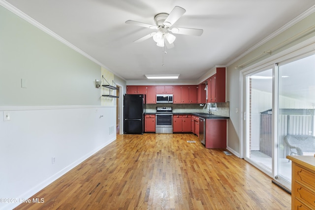 117 Brookfield Dr, Wilmington, NC 28405 - kitchen with appliances with stainless steel finishes, red cabinetry, a sink, light wood finished floors, and backsplash