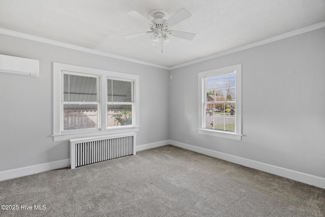 spare room with radiator heating unit, carpet, crown molding, and a wall mounted air conditioner