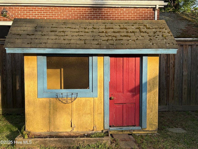 view of outbuilding with an outdoor structure and fence