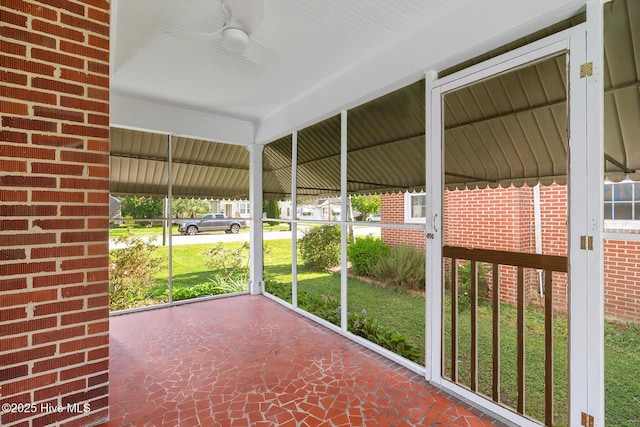 unfurnished sunroom with ceiling fan