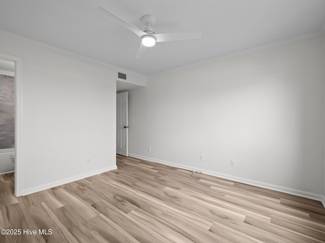 spare room with crown molding, light wood-type flooring, ceiling fan, and baseboards
