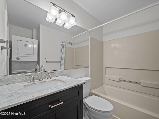 bathroom featuring stacked washer / dryer, toilet, vanity, and shower / bath combo