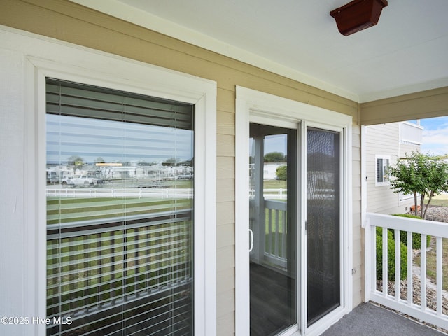 view of exterior entry featuring a balcony