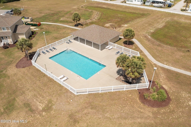 community pool with a fenced backyard